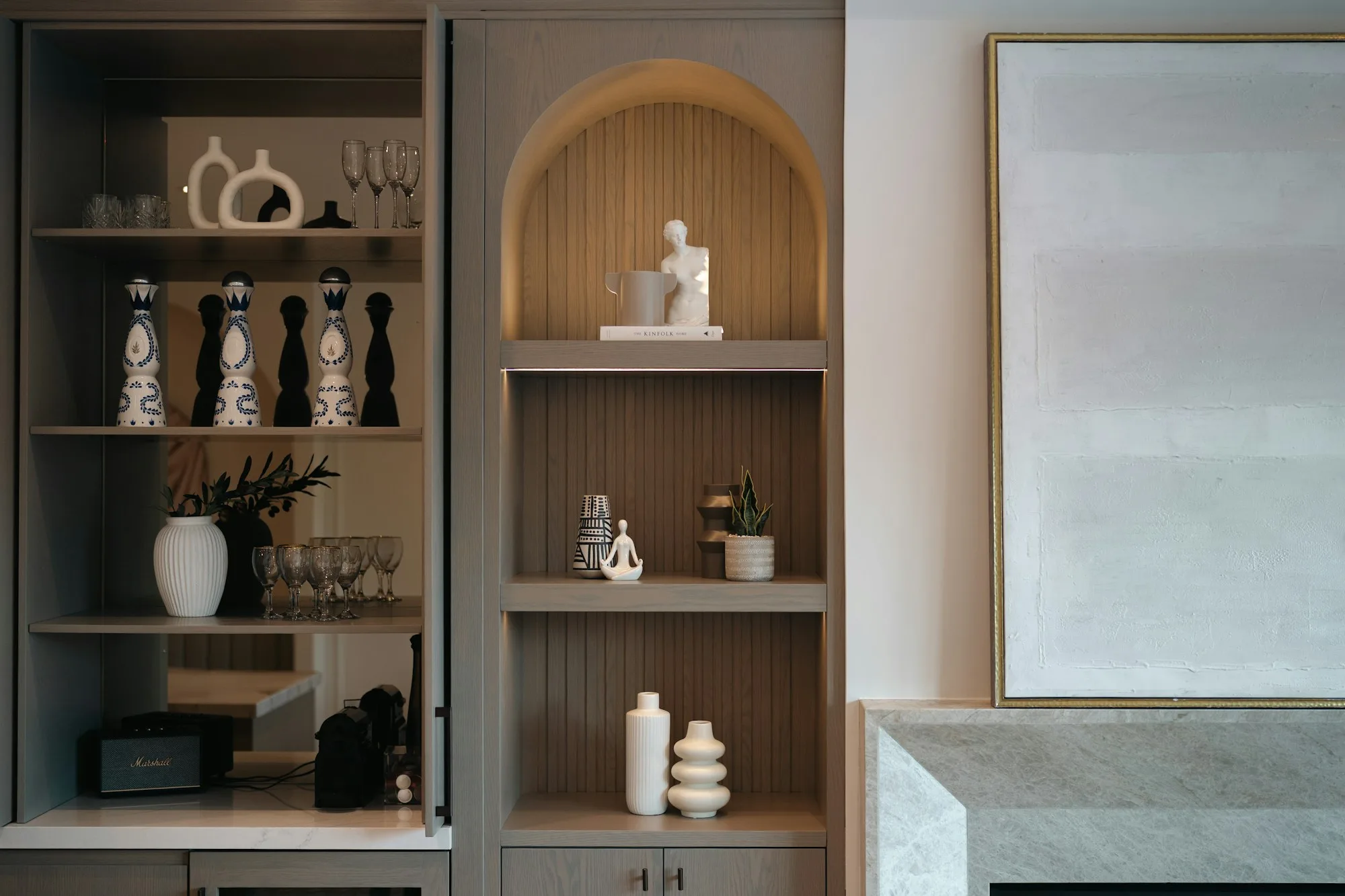 Modern display shelving with sculptural objects, vases and cabinet storage