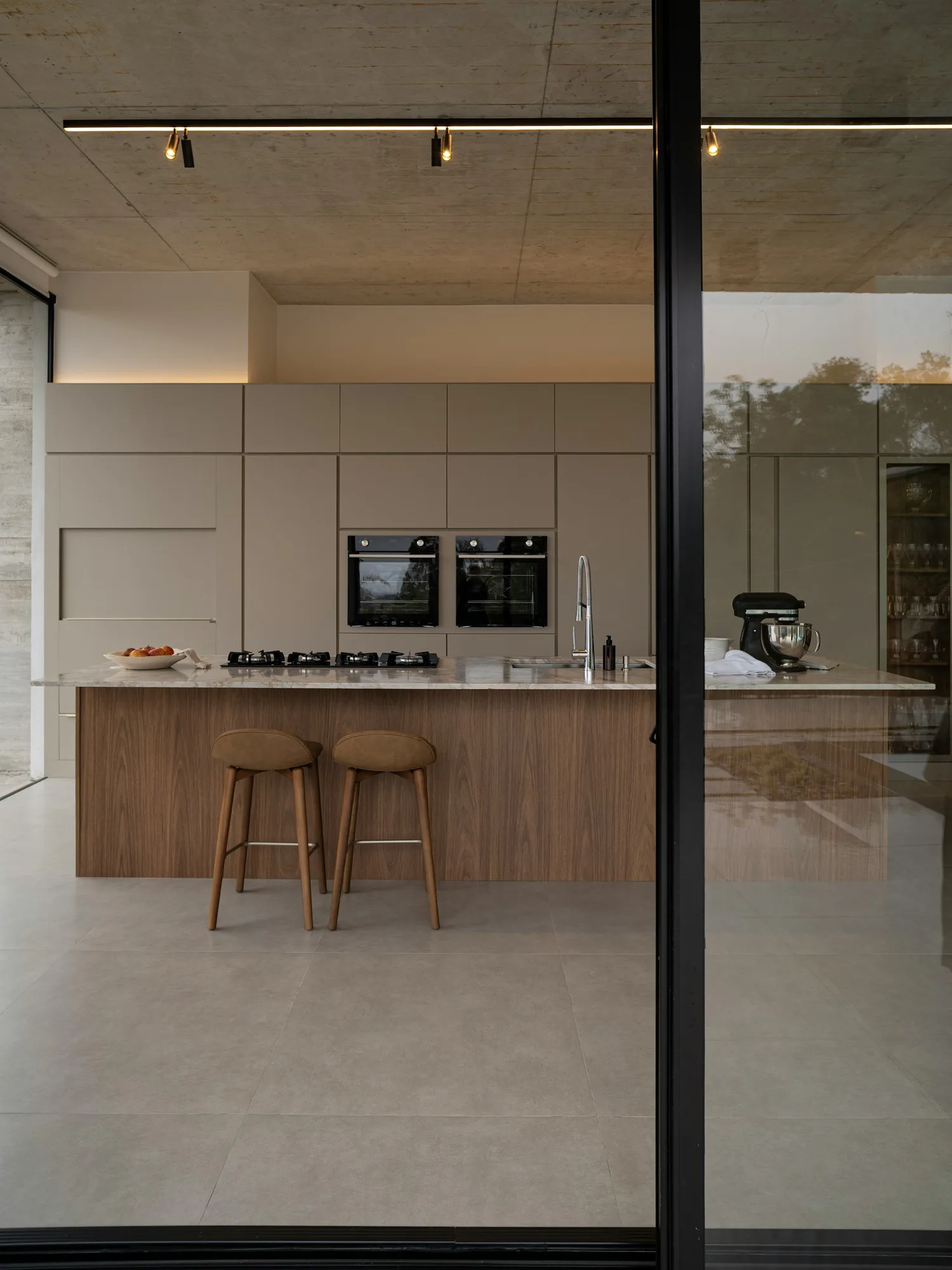Modern kitchen island with bar stools and streamlined cabinetry