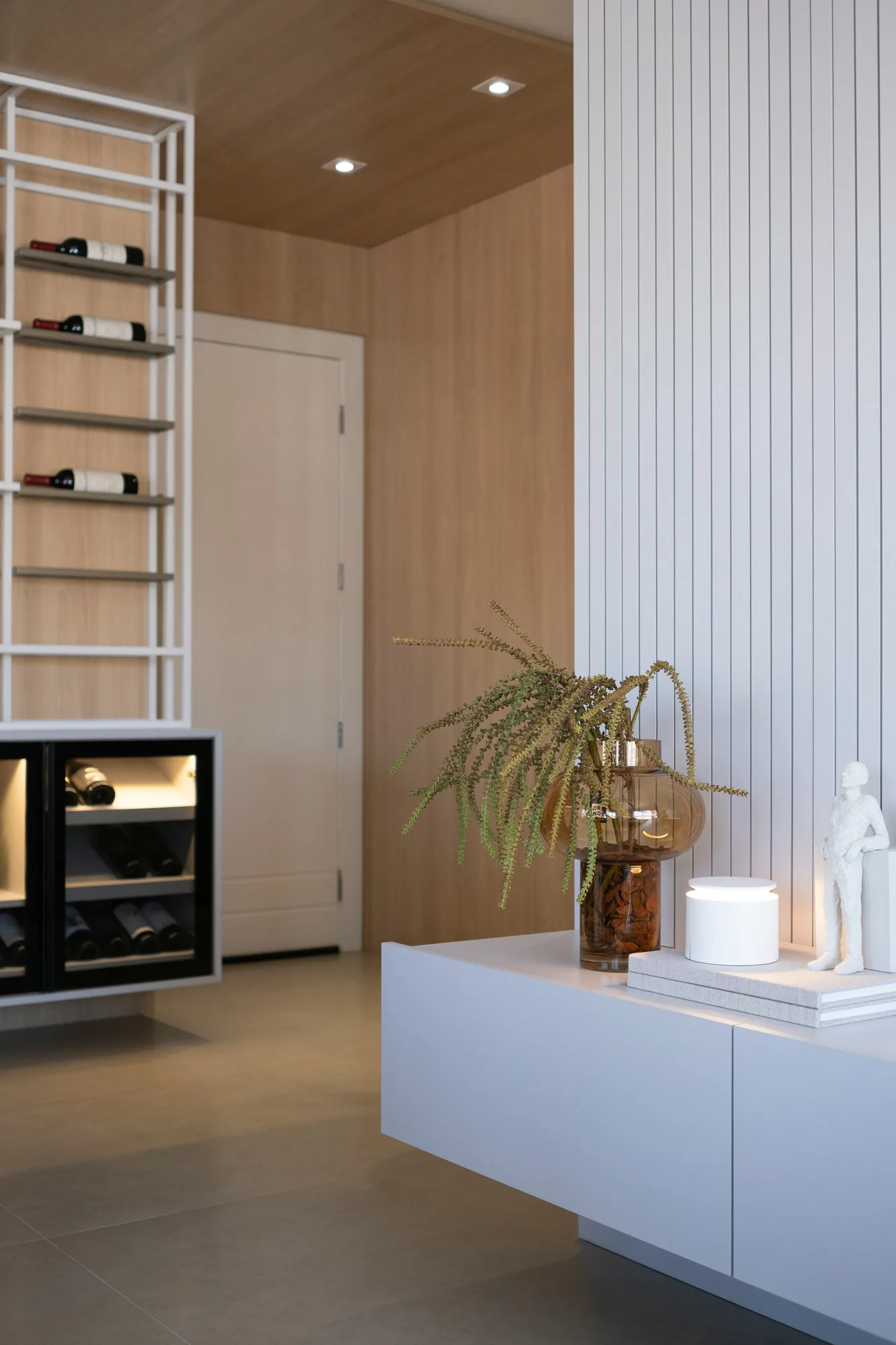 Modern interior with wine storage, display shelves and decorative objects